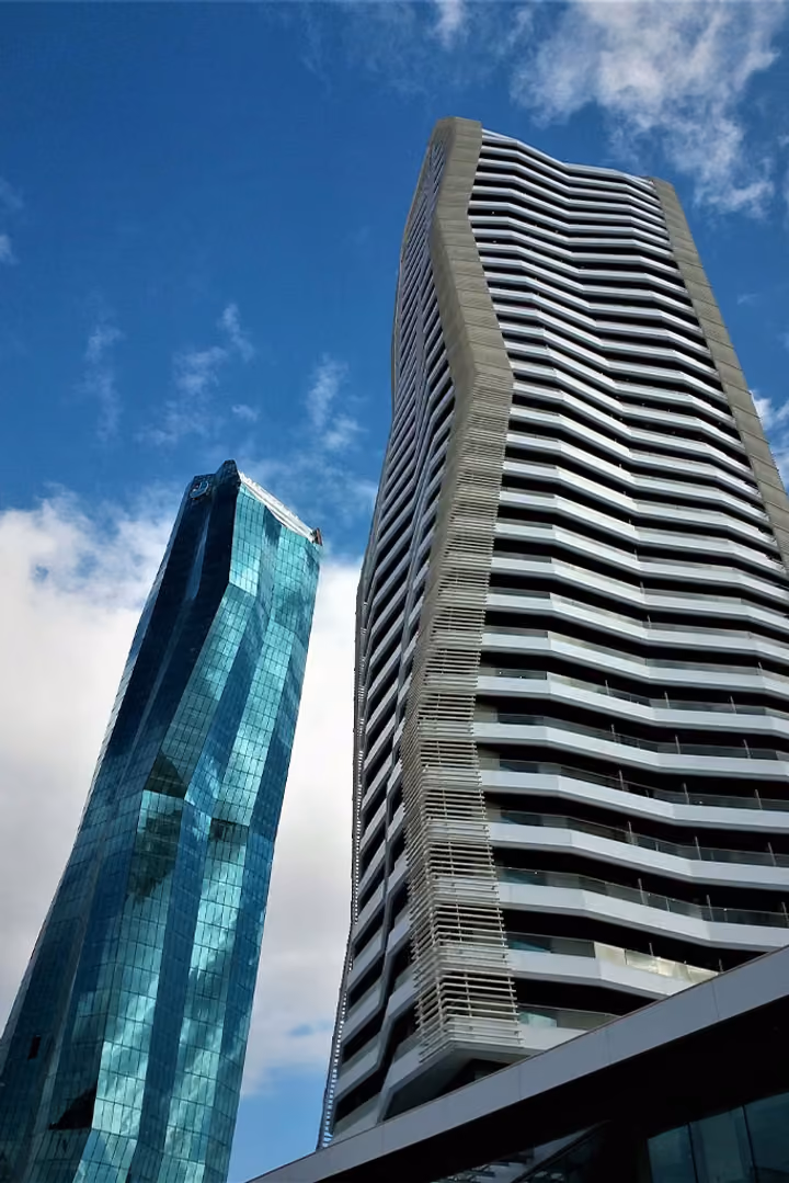 Residential tower balconies viewed from ground level.