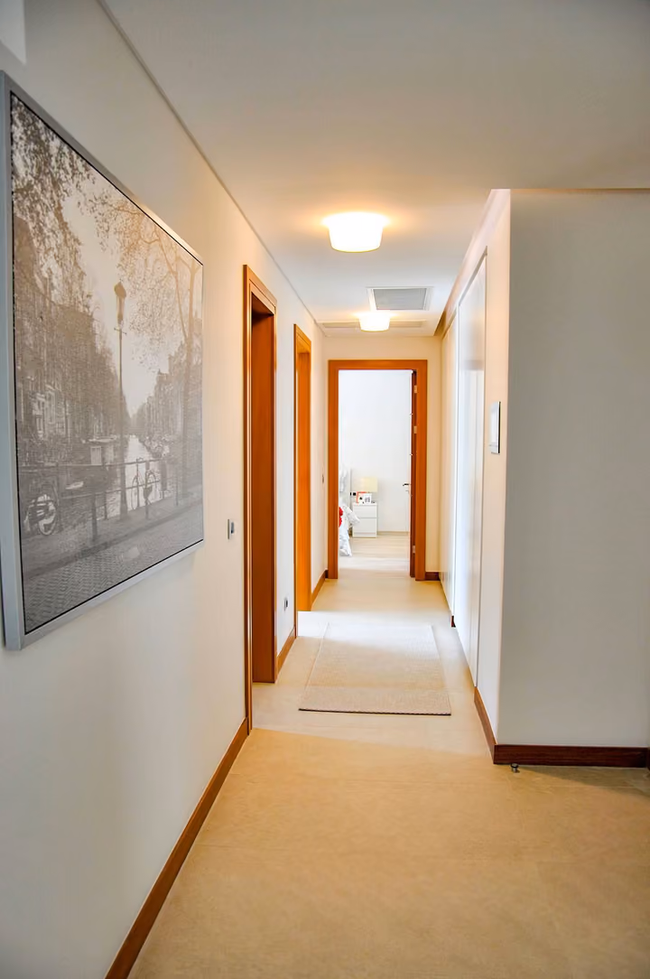 Interior hallway connecting apartment rooms.