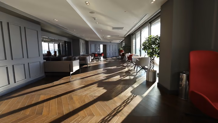Shared lounge with seating and large windows.