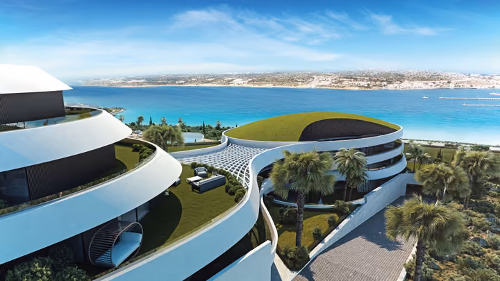 Architectural visualization across the stepped buildings and green roofs toward the bay.