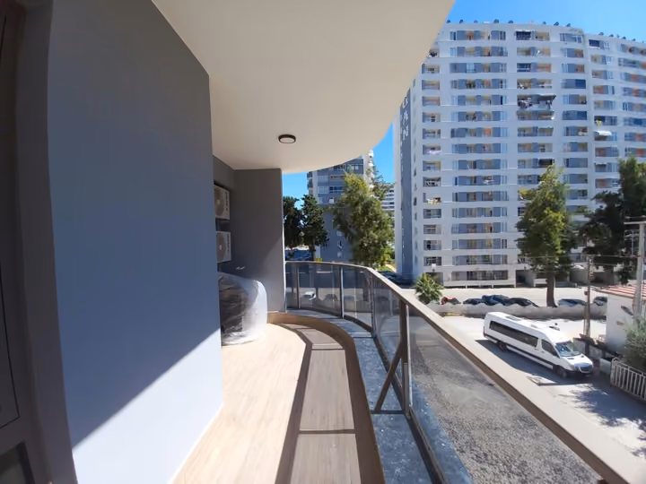 A curved balcony overlooking the surrounding residential street.
