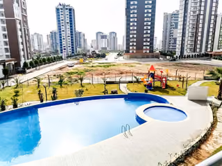 Outdoor swimming pool beside the shared gardens and playground.