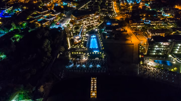 Illuminated coastal complex from above.