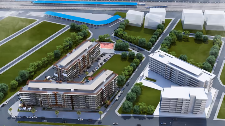 Architectural aerial rendering showing the building arrangement and landscaped courtyard from another direction.