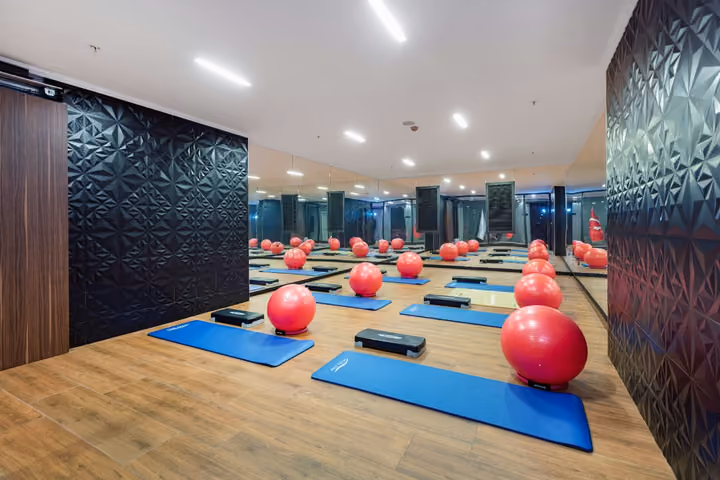 Photograph of fitness studio with mats and exercise balls.