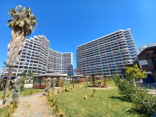 Residential buildings photographed across landscaped grounds and garden gazebos.