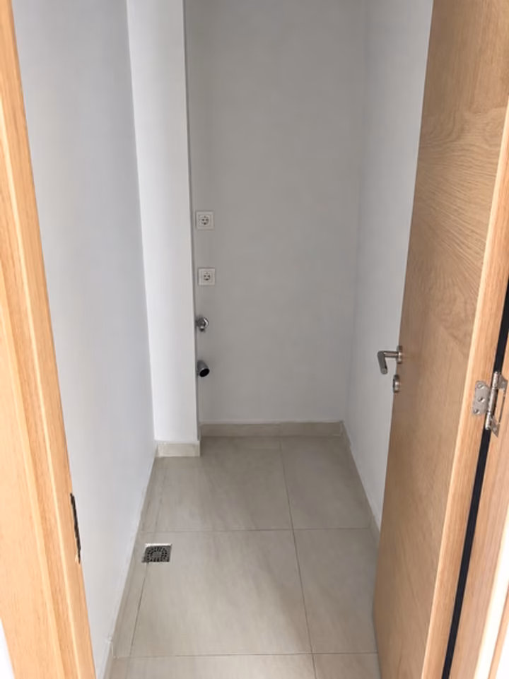 Narrow utility area beside a doorway.