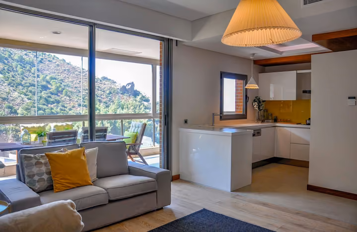 Open living area with kitchen and balcony access.