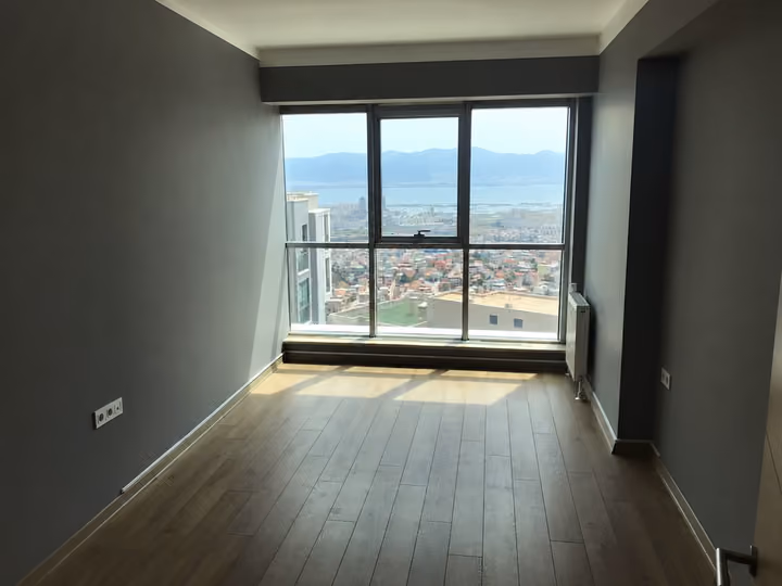 Bedroom with wide windows toward the bay.