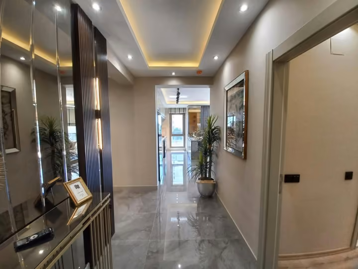 A show apartment entrance corridor with mirrored fitted storage.