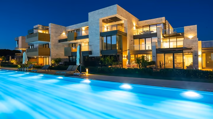 Illuminated residences beside the pool at night in Boyalik, Cesme.