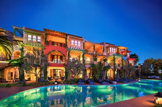 Architectural rendering of illuminated residences and shared pool at dusk in Alacati, Cesme.
