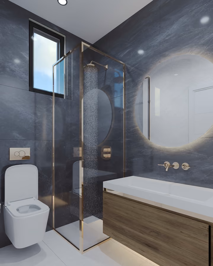 Bathroom with a glass shower enclosure, toilet, vanity and illuminated mirror.