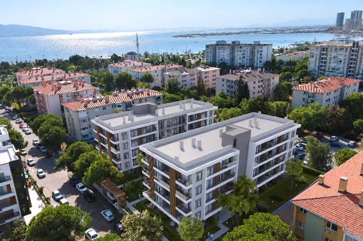 Architectural visualization of the development within its neighborhood, with the bay in the background.