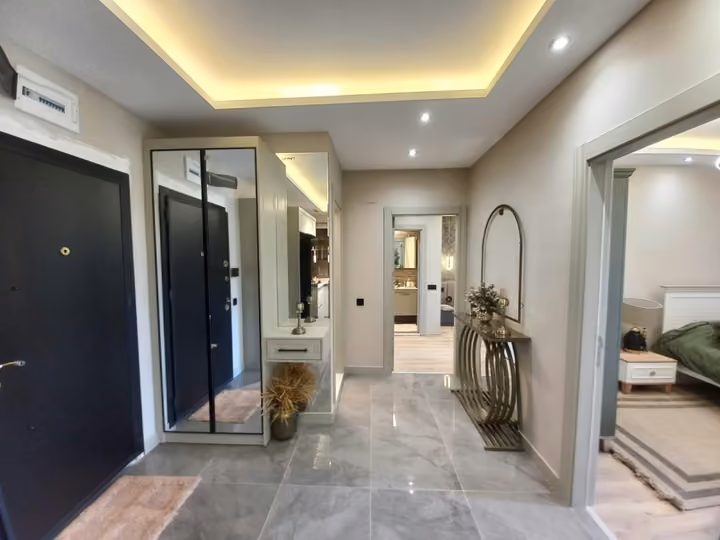 The entrance hall and fitted mirror storage in another furnished show apartment.