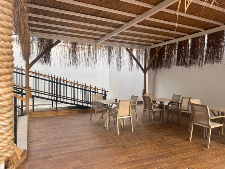 Covered terrace with tables and chairs