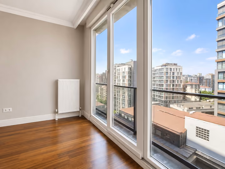 Living room window overlooking surrounding apartment buildings.