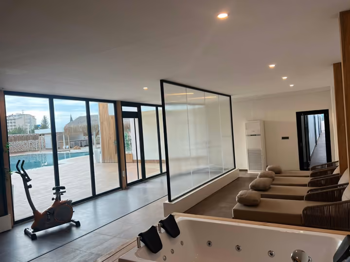 Fitness equipment and relaxation seating beside the pool
