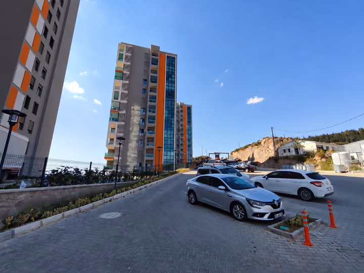 Open parking beside the residential buildings.