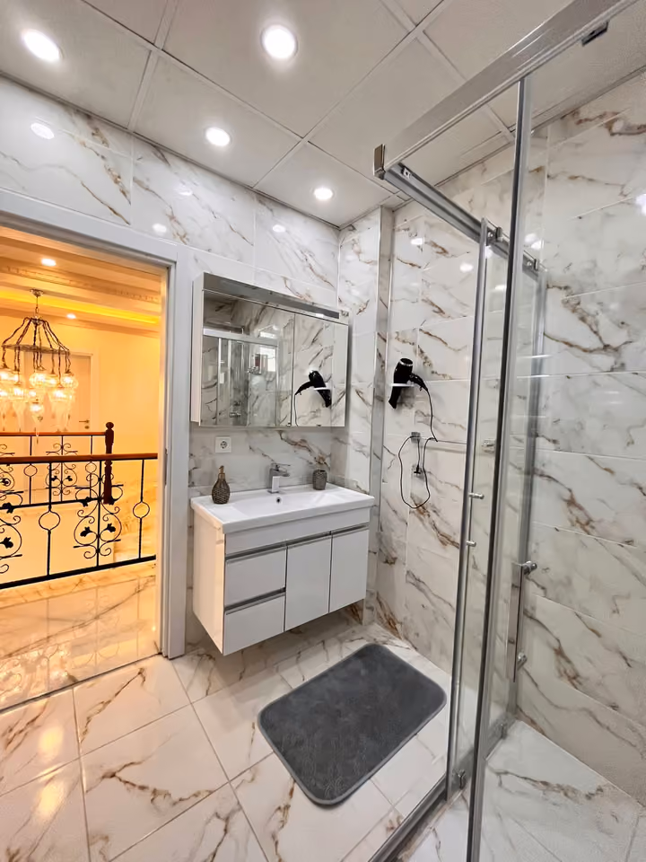Bathroom vanity and shower in the furnished seafront mansion in Buyukcekmece.