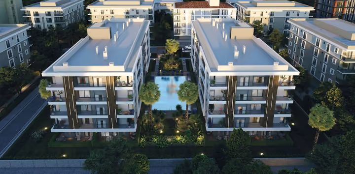 Architectural visualization showing two apartment blocks around the illuminated outdoor pool.