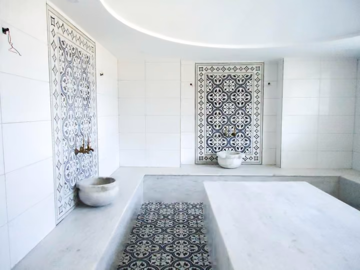 Shared Turkish bath with a central marble platform.