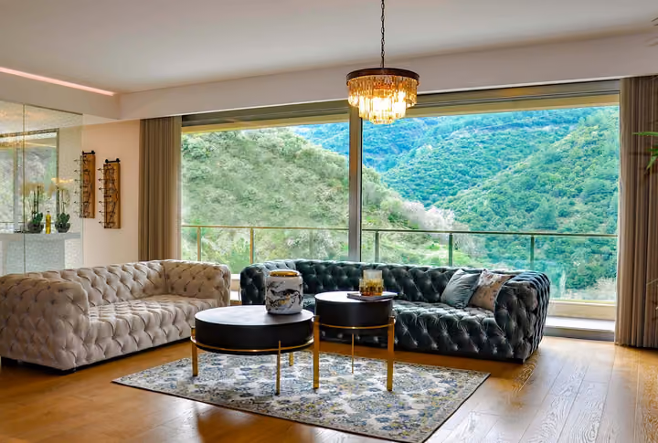 Sitting room with large windows and hillside views.