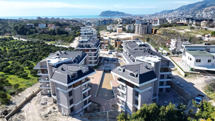 Aerial photograph of four residential blocks in Oba Alanya taken in February 2026