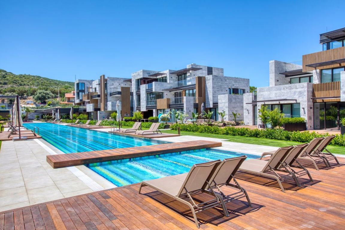 Outdoor swimming pool and landscaped apartment buildings in Boyalik, Cesme.