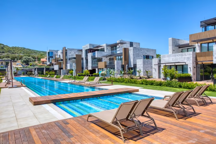 Outdoor swimming pool and landscaped apartment buildings in Boyalik, Cesme.