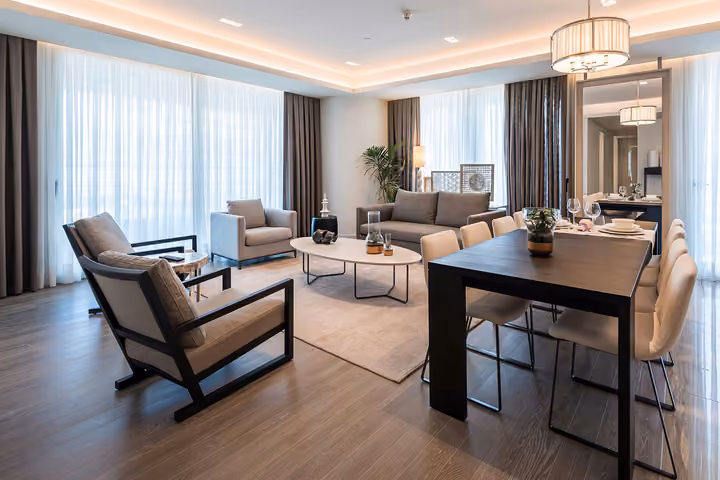 Wide view of a furnished living and dining room.