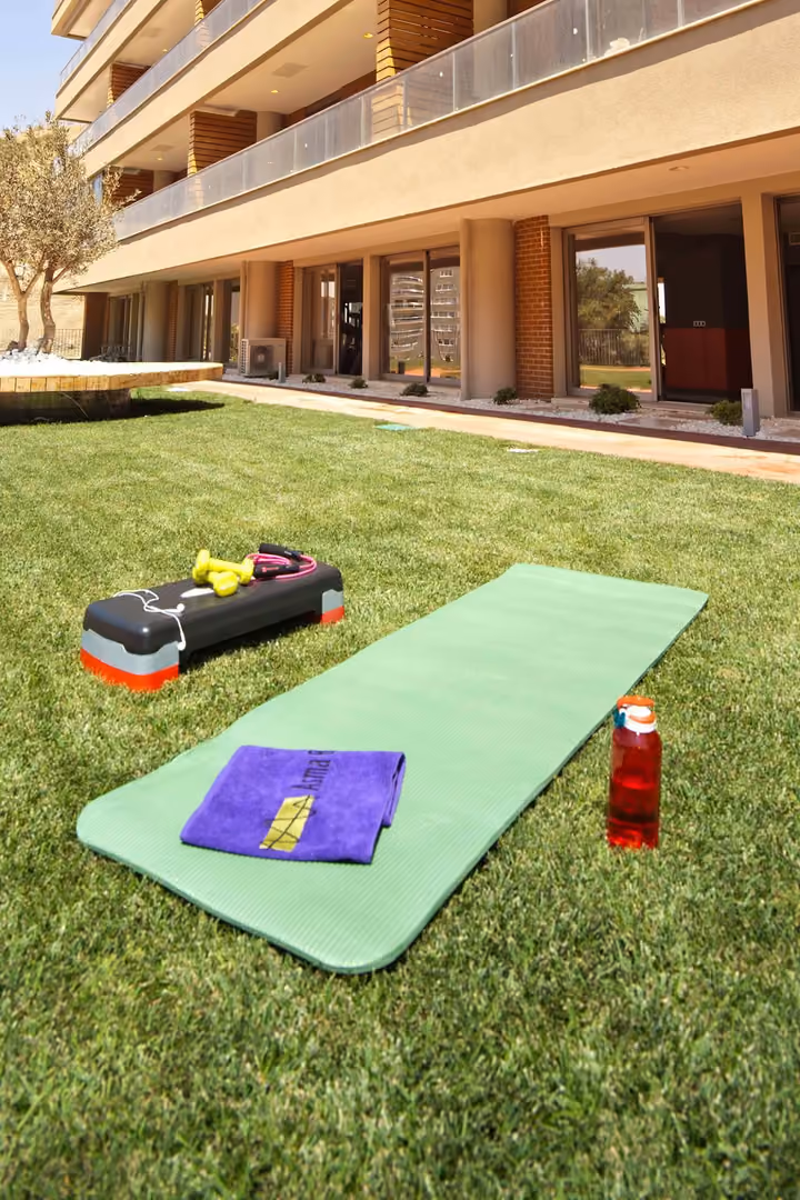Exercise mats on a lawn beside the residences.