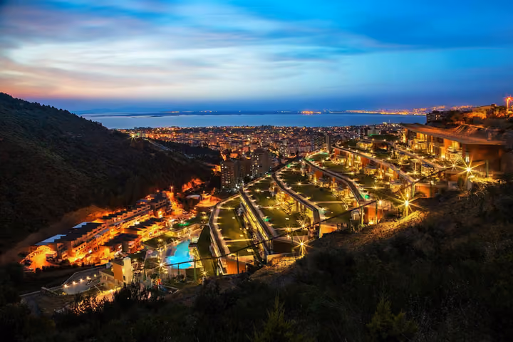 Wide evening view of the terraced residences and bay.