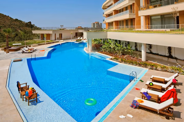 Daytime overview of the outdoor pool and sun terrace.