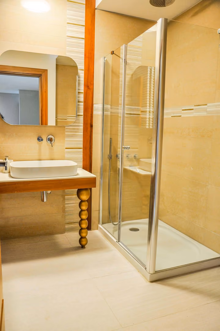 Bathroom with shower enclosure and vanity.