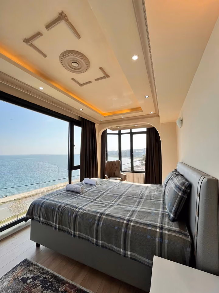 Sea view bedroom checkered bedding in the furnished seafront mansion in Buyukcekmece.