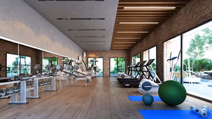 Rendering of a shared fitness room with exercise machines and garden-facing windows.