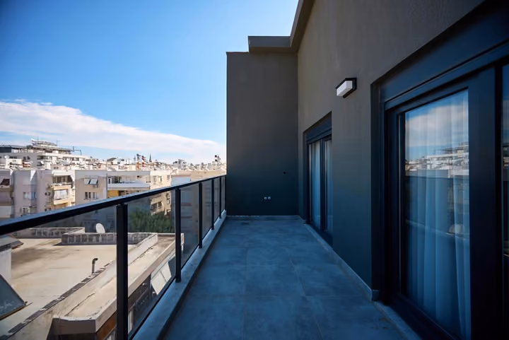 Balcony with a glass balustrade overlooking the surrounding residential streets.