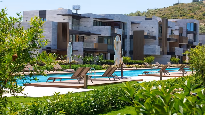 Poolside loungers beside planted gardens in Boyalik, Cesme.