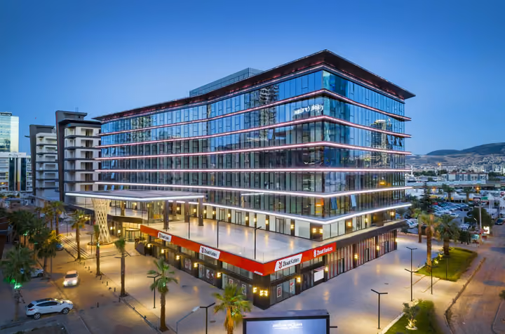 Photograph of office building and ground-floor retail.