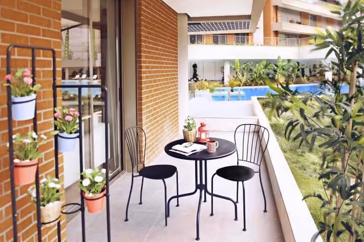 Balcony dining corner overlooking the communal pool.
