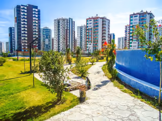 Landscaped walking path through the shared grounds between apartment buildings.