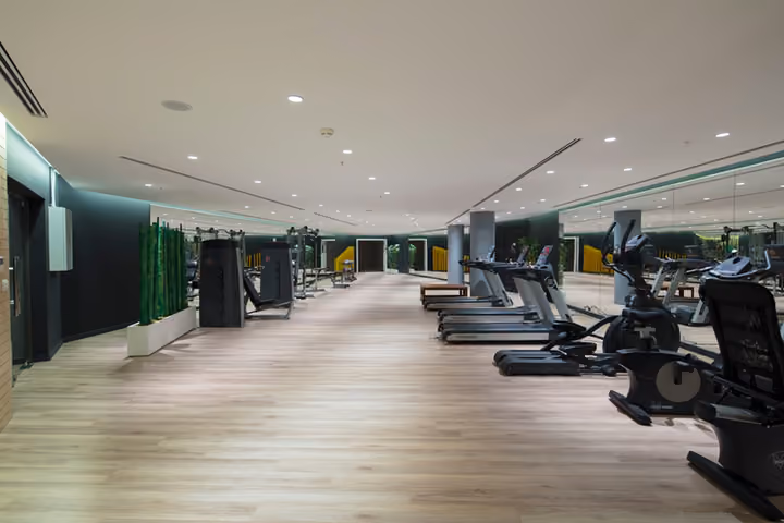 Fitness room with cardio equipment.