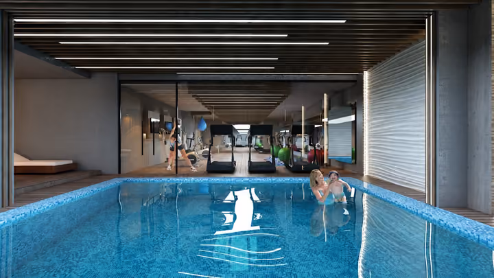 Interior rendering of an indoor swimming pool with glazing, seating and adjacent fitness space.