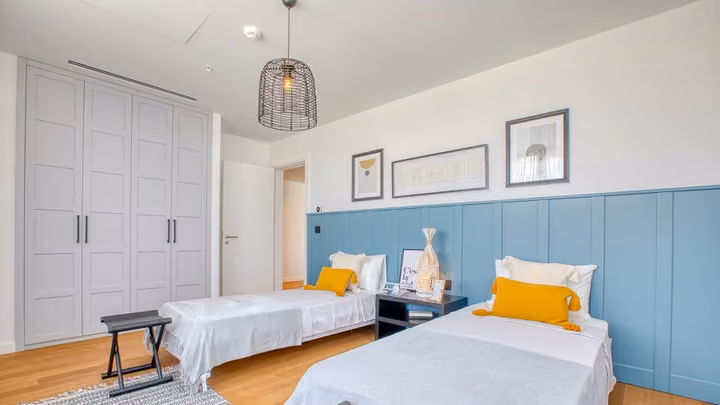 Twin bedroom with blue wall panels in Boyalik, Cesme.