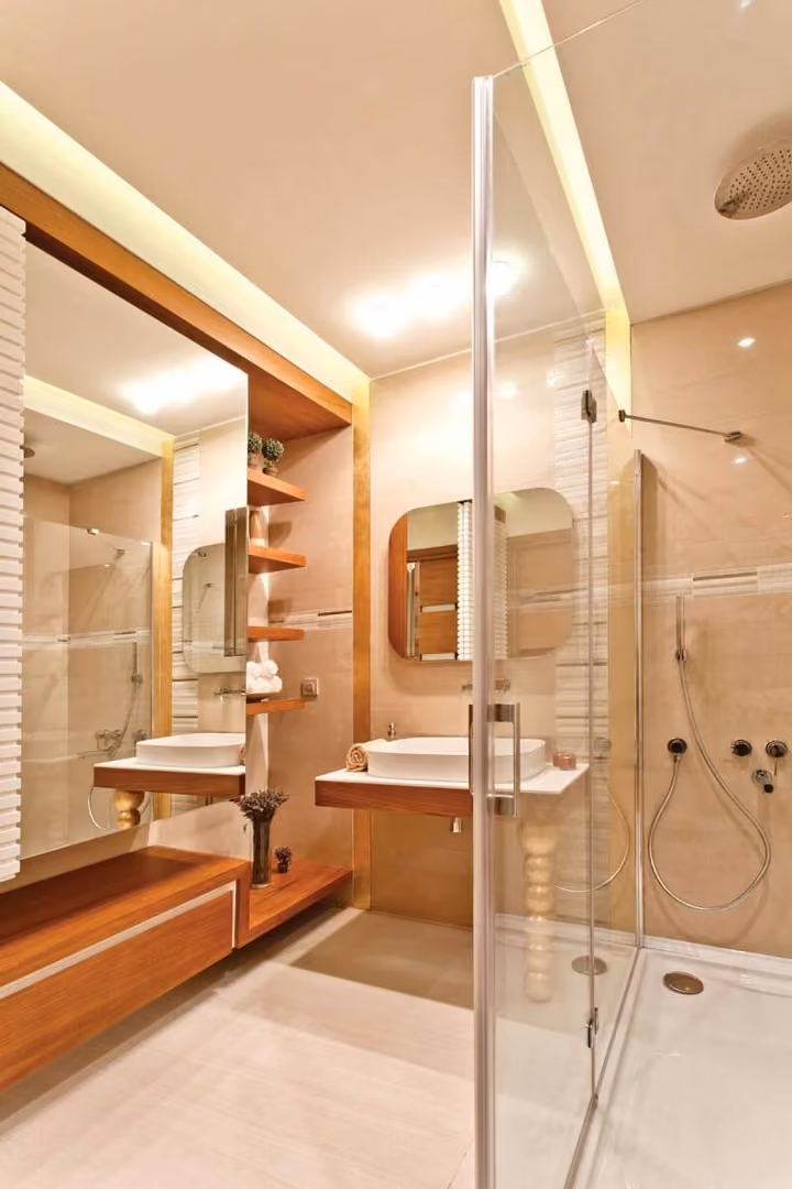 Bathroom with glass shower enclosure and vanity.