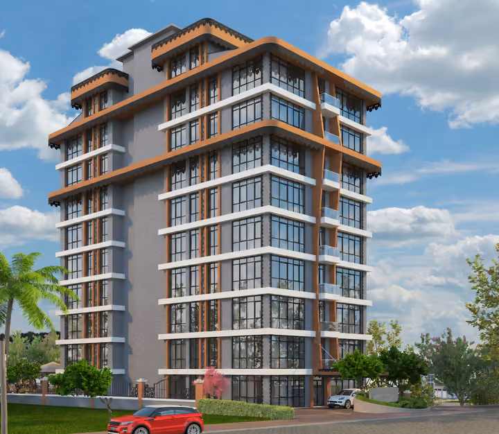 Apartment building with glass balconies and a landscaped entrance.