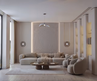 Living room with a sofa, armchairs, coffee table and decorative wall panels.