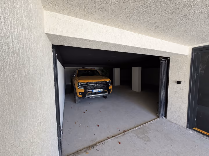 Covered garage and vehicle entrance beneath the villa.
