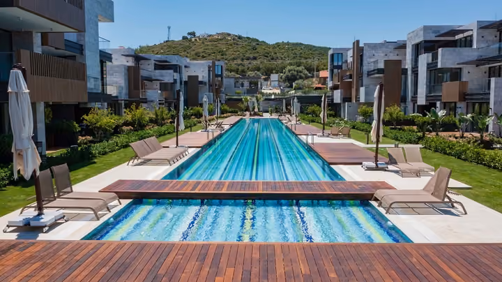 Long outdoor pool between apartment buildings in Boyalik, Cesme.